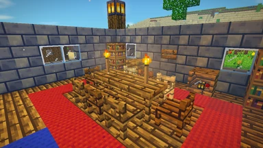 A stone hall open to the sky: a long oak table lit by torches, chairs of four woods round it, a shelf of goods and a carved sign on the back wall.
